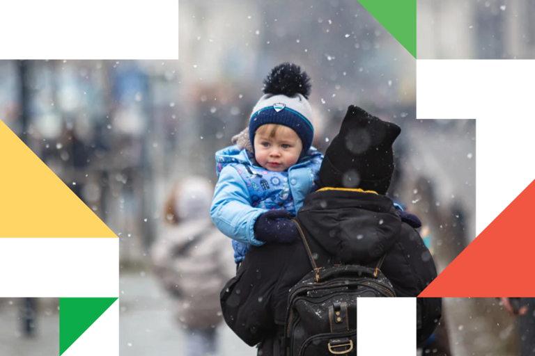 A woman carrying a child on her back.