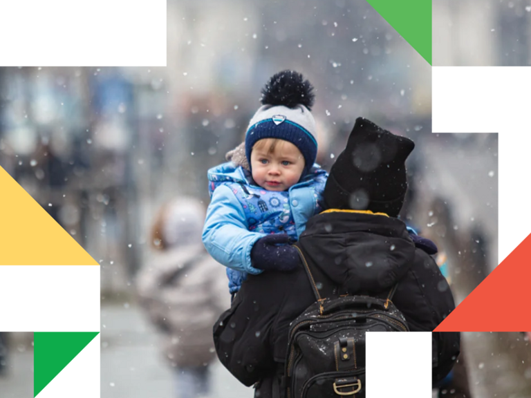 A woman carrying a child on her back.