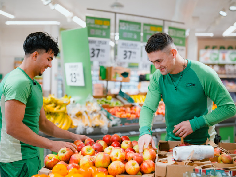 A couple of men standing next to each other in a store.