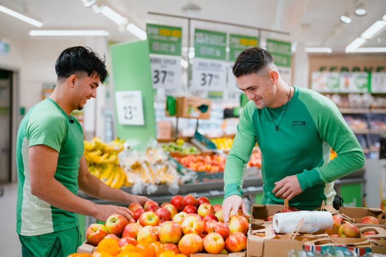 A couple of men standing next to each other in a store.
