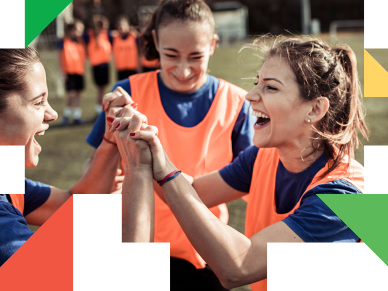 A group of young women holding hands in front of each other.