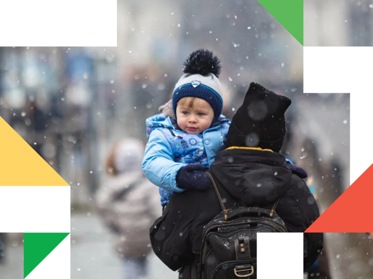 A woman carrying a child on her back.